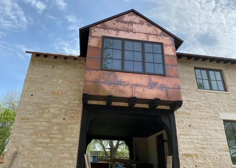Copper metal panel facade on a stone building for Skylight Installation in Sylacauga